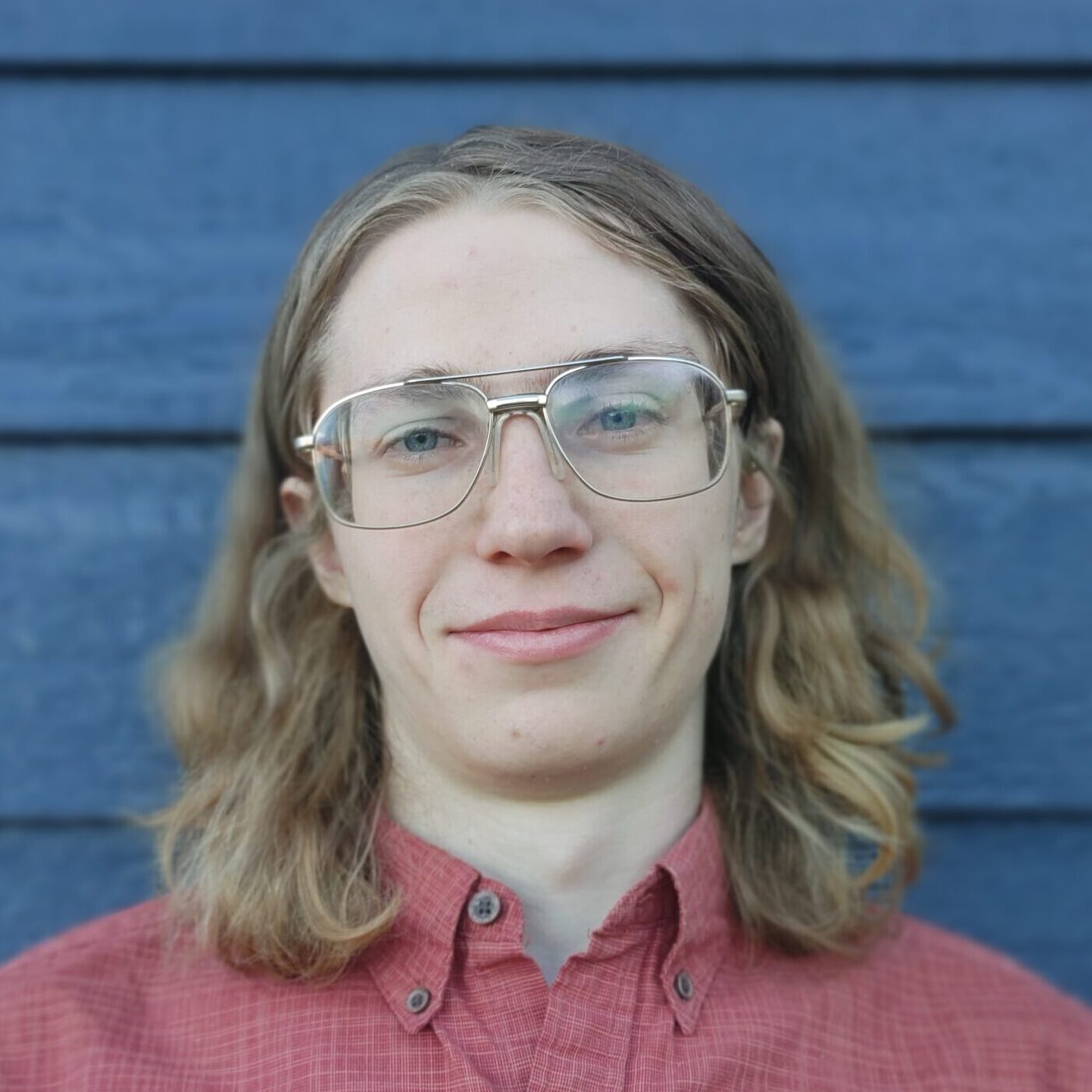 Profile image of myself wearing a red shirt against a blue background